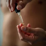 Man applying arousal oil to his penis