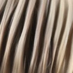 Close-up view of k tip hair extensions attached to natural hair