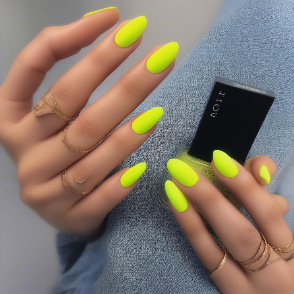 Matte neon yellow nails on a hand.