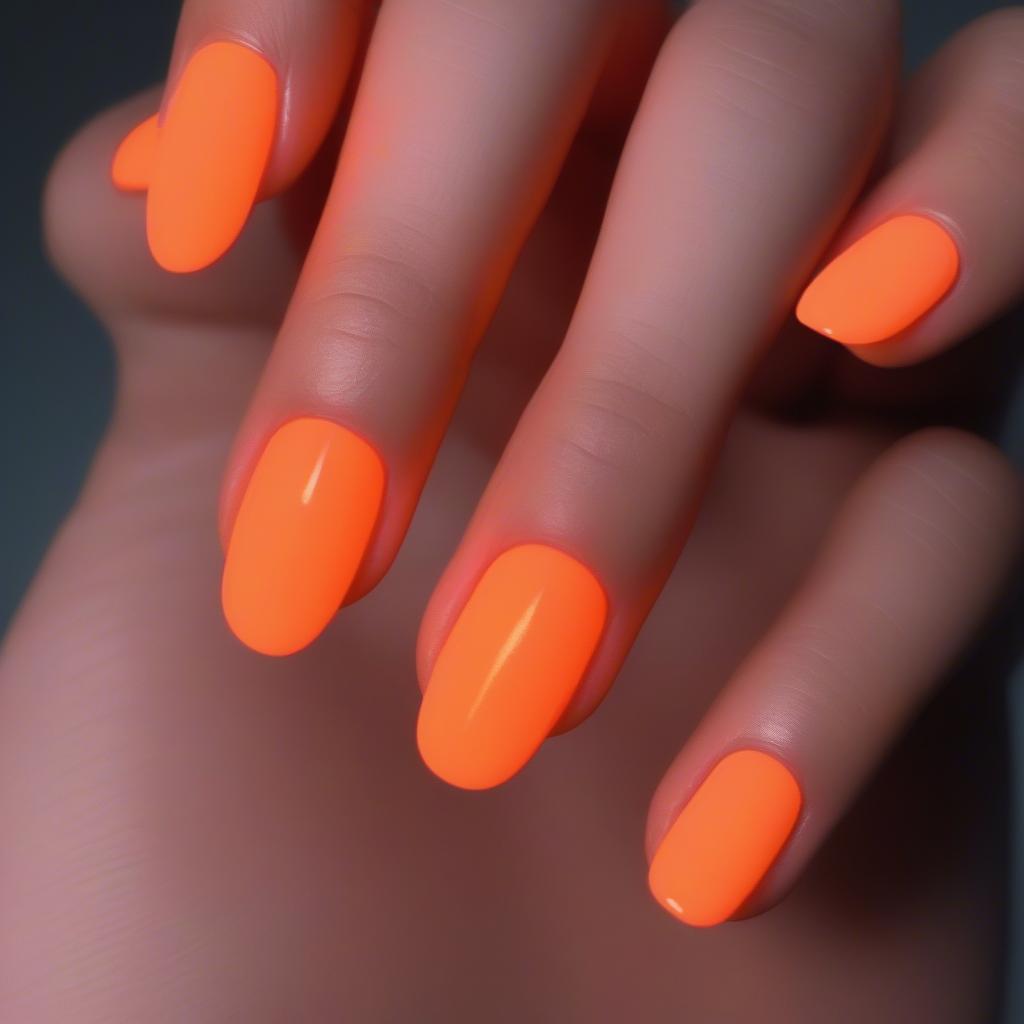 Orange Glow Nails in a Dark Setting