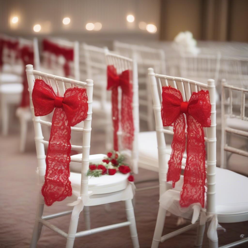 Red lace bow used as wedding decor on chairs