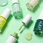 Various shades of spring green nail polish, from pastel mint to vibrant emerald.