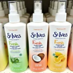 Different scents of St. Ives Fresh Hydration Lotion Spray lined up on a shelf.