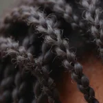 Close-up of dry and brittle African hair cuticle showing the need for moisture.