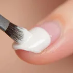 Applying whipped polish on nails with a brush