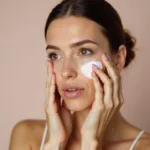 Woman applying blur cream