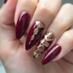 Burgundy Nails with Gold Accent Design