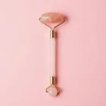 Facial Roller and Gua Sha Set on a Pink Background