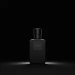 A dark and moody photograph of a licorice perfume bottle against a black background, highlighting its elegant design and mysterious allure.