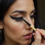 Woman applying traditional kohl eyeliner