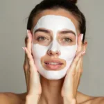 Woman applying an image hydrating mask